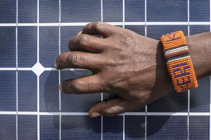 Person's hand grabbing solar panel