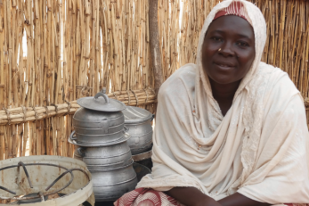woman sitting near pots