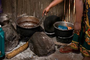 a person cooking food in a pot