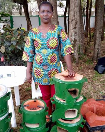 woman standing with cooking pots